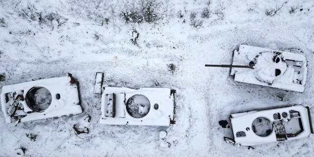 BUCHA, UKRAINE - DECEMBER 05: A man views destroyed Russian tanks outside Bucha on December 05, 2022 in Bucha, Ukraine. 