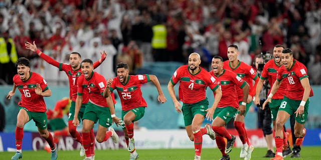 Morocco's players celebrate after a penalty shootout at a World Cup round of 16 soccer match against Spain at the Education City Stadium in Al Rayyan, Qatar, Tuesday, Dec. 6, 2022. 