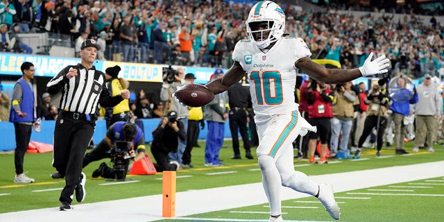 Miami Dolphins wide receiver Tyreek Hill runs for a touchdown after recovering a fumble during the first half against the Los Angeles Chargers, Sunday, Dec. 11, 2022, in Inglewood, California.