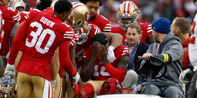 San Francisco 49ers wide receiver Deebo Samuel, middle, reacts as he is carted off the field during the first half of an NFL football game against the Tampa Bay Buccaneers in Santa Clara, California, Sunday, Dec. 11, 2022. 