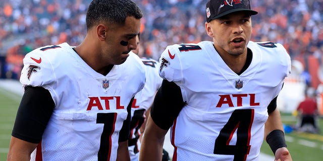 Marcus Mariota #1 and Desmond Ridder #4 of the Atlanta Falcons walk off the field after the game against the Cincinnati Bengals at Paul Brown Stadium on October 23, 2022 in Cincinnati, Ohio.