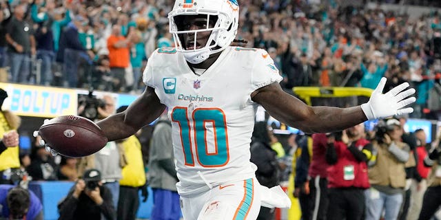 Miami Dolphins wide receiver Tyreek Hill scores a touchdown after recovering a fumble during the Los Angeles Chargers game, Sunday, Dec. 11, 2022, in Inglewood, California.