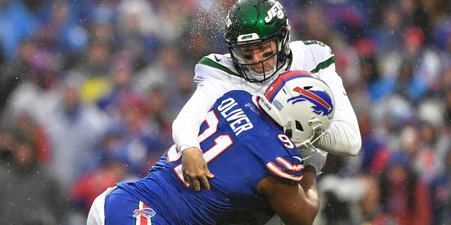 Buffalo Bills defensive tackle Ed Oliver (91) collides with New York Jets quarterback Mike White (5) during the first half of an NFL football game, Sunday, Dec. 11, 2022, in Orchard Park, New York. 