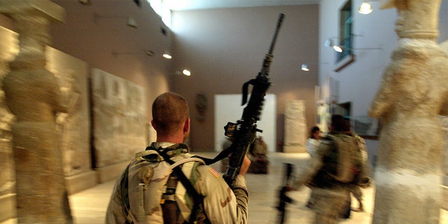 Two US soldiers from the 1st Division, 2nd Bridage, Texas, visit the Iraq Museum 10 September 2003 in Baghdad.