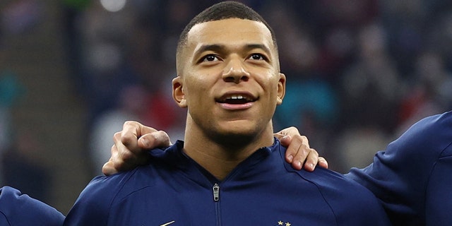 France's Kylian Mbappe lines up during the national anthems before the match.