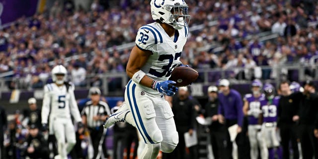 Julian Blackmon (32) of the Indianapolis Colts returns the ball for a pick-six against the Minnesota Vikings during the second quarter of a game at U.S. Bank Stadium Dec. 17, 2022, in Minneapolis.