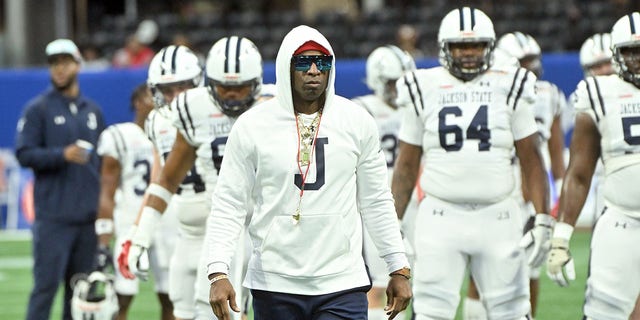 Head coach Deion Sanders of the Jackson State Tigers walks the field during pregame warmups prior to the Cricket Celebration Bowl against the North Carolina Central Eagles at Mercedes-Benz Stadium Dec. 17, 2022, in Atlanta.