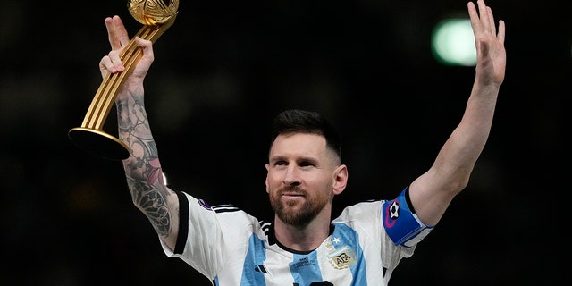 Argentina's Lionel Messi waves after receiving the Golden Ball award for best player of the tournament at the end of the World Cup final soccer match between Argentina and France at the Lusail Stadium in Lusail, Qatar, Sunday, Dec. 18, 2022. 