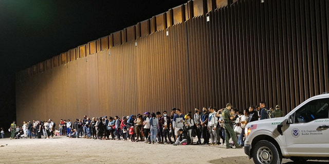 Migrants attempting to cross in to the U.S. from Mexico are detained by U.S. Customs and Border Protection at the border August 20, 2022 in San Luis, Arizona.