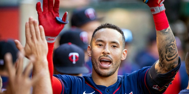 FILE - Minnesota Twins' Carlos Correa, right, is congratulated after hitting a solo home run against the Los Angeles Angels during the first inning of a baseball game in Anaheim, Calif., Saturday, Aug. 13, 2022. 