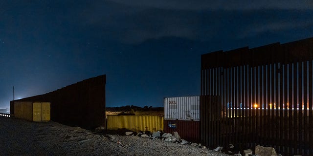 General view of shipping containers being installed to fill gaps in the unfinished wall along the U.S.-Mexico border, in Yuma, Arizona, on Aug. 16, 2022.