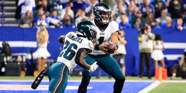 Jalen Hurts (1) of the Philadelphia Eagles hands the ball off to Miles Sanders (26) in the third quarter against the Indianapolis Colts at Lucas Oil Stadium Nov. 20, 2022, in Indianapolis.