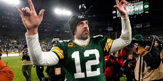 Packers quarterback Aaron Rodgers waves to fans as he leaves the field following the Los Angeles Rams game in Green Bay, Wisconsin, Dec. 19, 2022.