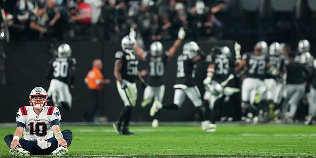 Mac Jones (10) of the New England Patriots reacts after losing to the Las Vegas Raiders at Allegiant Stadium Dec. 18, 2022, in Las Vegas. 