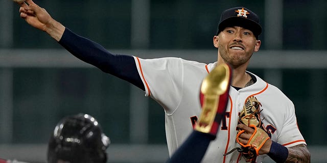 FILE - Houston Astros shortstop Carlos Correa forces Boston Red Sox's Alex Verdugo out at second after Christian Arroyo hit into a double play during the second inning in Game 1 of baseball's American League Championship Series on Oct. 15, 2021, in Houston.