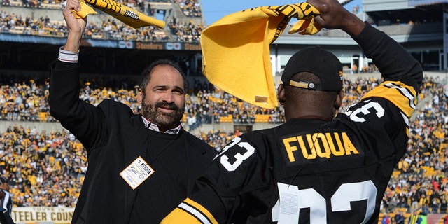 Franco Harris (L) and John Fuqua #33, former running backs for the Pittsburgh Steelers, wave Terrible Towels before a game between the Steelers and Cincinnati Bengals at Heinz Field on December 23, 2012, in Pittsburgh, Pennsylvania.