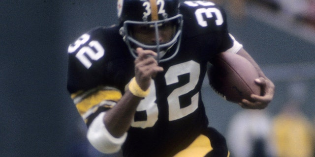 Running back Franco Harris #32 of the Pittsburgh Steelers plays carries the ball against the Denver Broncos circa mid 1970s during an NFL football game at Three Rivers Stadium in Pittsburgh, Pennsylvania. Harris  played for the Steelers from 1972-83.