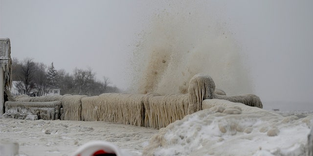 Ice and snow cover a railing along the Lake Erie shoreline on Dec. 24, 2022 in Hamburg, New York.