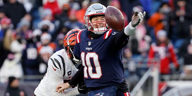 Vonn Bell, #24 of the Cincinnati Bengals, pressures Mac Jones, #10 of the New England Patriots, as he attempts a pass during the fourth quarter at Gillette Stadium on Dec. 24, 2022 in Foxborough, Massachusetts.