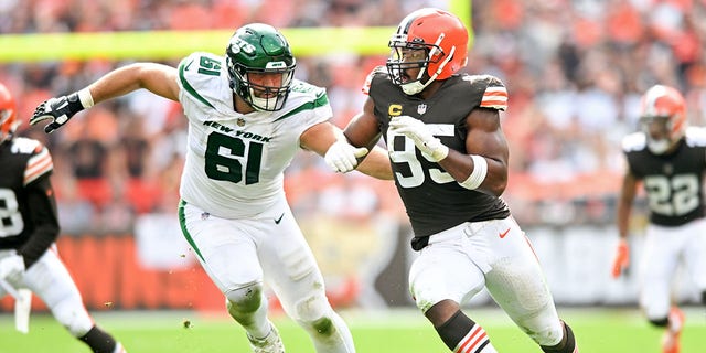 Myles Garrett #95 of the Cleveland Browns rushes against Max Mitchell #61 of the New York Jets during the second half at FirstEnergy Stadium on September 18, 2022 in Cleveland, Ohio.