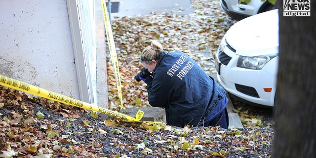 State police forensics personnel look for clues at a rental house in Moscow, Idaho, on Nov. 21, 2022. Four University of Idaho students were stabbed to death in the house on Nov. 13.