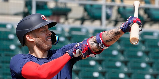 Minnesota Twins' Carlos Correa adjusts his arm protector during batting batting practice at Hammond Stadium Wednesday March 23, 2022, in Fort Myers, Fla. 