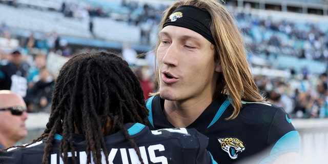 Rayshawn Jenkins of the Jacksonville Jaguars, left, hugs Trevor Lawrence on the field after a game against the Dallas Cowboys at TIAA Bank Field Dec. 18, 2022, in Jacksonville, Fla.