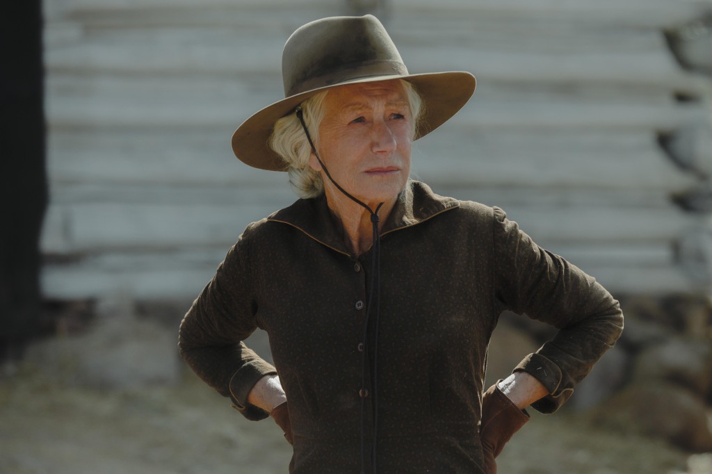 Helen Mirren as Cara Dutton. She's wearing a hat and her gloved hands are on her waist. She has a serious look on her face.