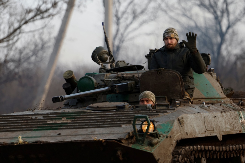 Ukrainian servicemen ride in a tank on Dec. 25. 