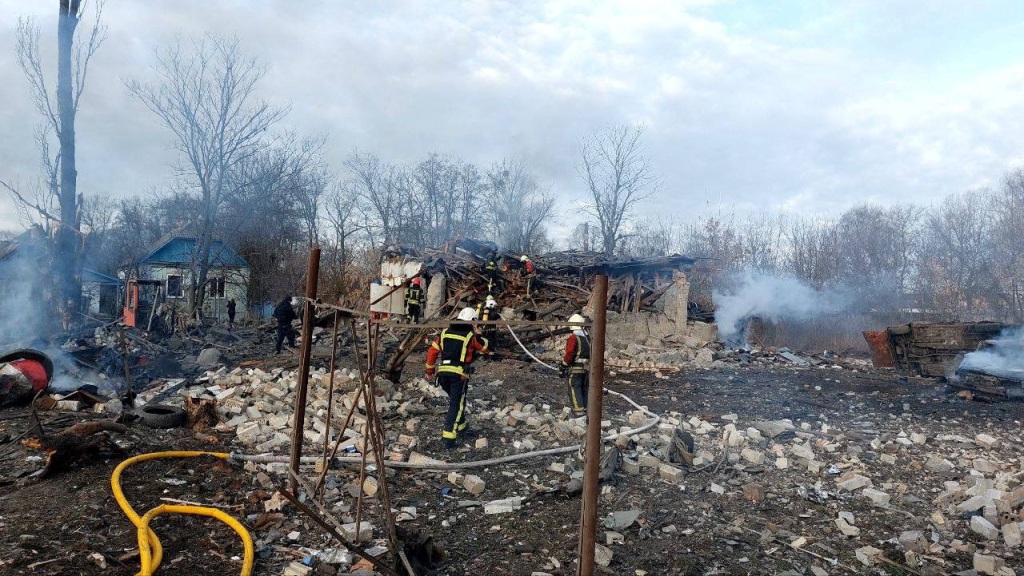 Rescuers workers at a house heavily damaged by a Russian missile strike.