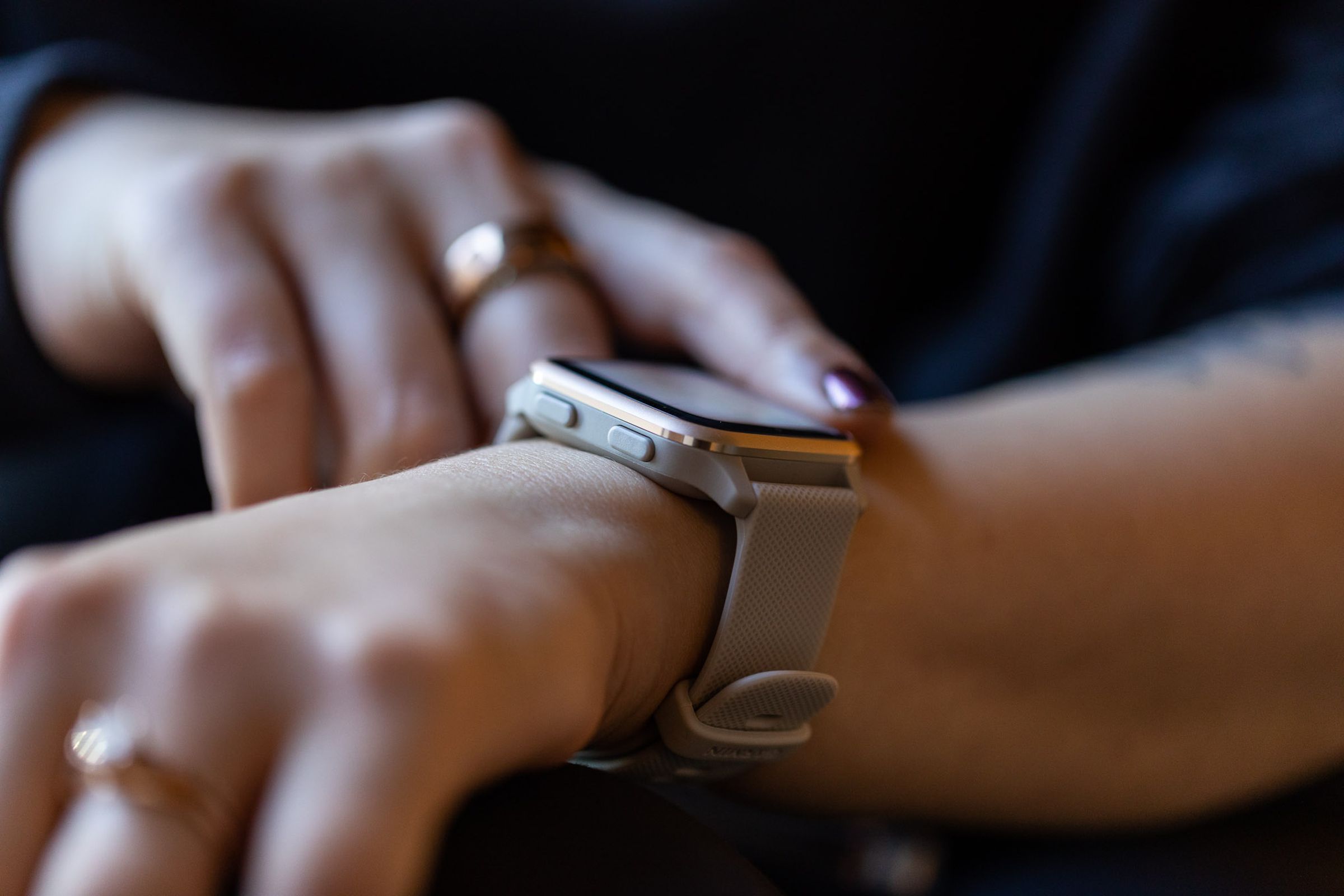 A side view of the Garmin Venu Sq 2 on a woman’s wrist, showing the aluminum bezel and buttons 