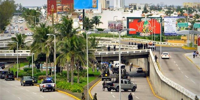  Soldiers and police block off an area where 35 bodies lie under an overpass in Veracruz, Mexico. 