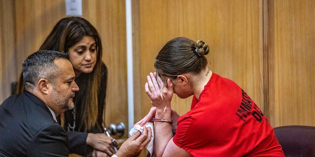 Defense attorneys Sabrina Puglisi and Frank Prieto talked to their client, OnlyFans model Courtney Clenney, as she reacts after Judge Laura Shearon Cruz’s decision to deny for her to get out of jail to await trial. She is accused of murdering her boyfriend Christian Obumseli on April 3, 200, in Miami. The hearing took place at the at the Richard E. Gerstein Justice Building, in Miami, on Dec. 8, 2022.