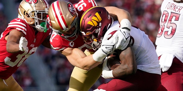 San Francisco 49ers defensive end Nick Bosa (97) tackles Washington Commanders running back Brian Robinson Jr. in the first half of an NFL football game, Saturday, Dec. 24, 2022, in Santa Clara, Calif. 