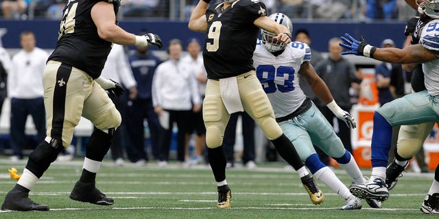 New Orleans Saints quarterback Drew Brees, #9, passes the ball against the Dallas Cowboys during the first half of an NFL football game on Sunday, Dec. 23, 2012, in Arlington, Texas.