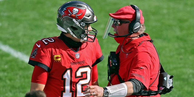 Buccaneers head coach Bruce Arians congratulates quarterback Tom Brady after a touchdown pass against the Minnesota Vikings, Dec. 13, 2020, in Tampa, Florida.