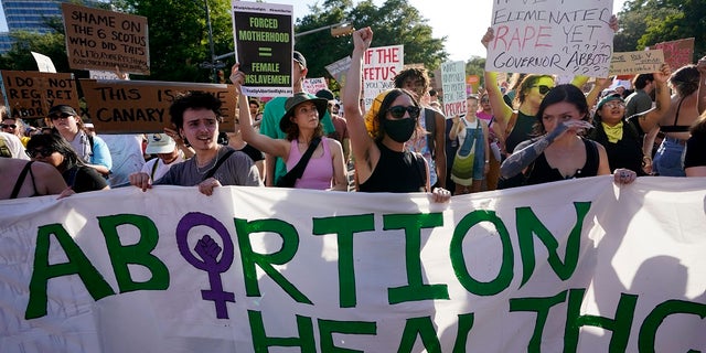 Demonstrators march and gather near the state capitol following the Supreme Court's decision to overturn Roe v. Wade in Austin, Texas. Texas Attorney General Ken Paxton is being sued by health care providers over allegedly threatening ot prosecute abortion providers.