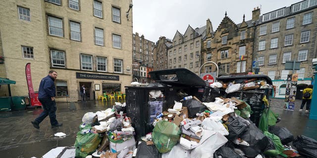 A view of overflowing bins in the Grassmarket area of Edinburgh where cleansing workers from the City of Edinburgh Council are on the fourth day of eleven of strike action, in Scotland, Wednesday, Aug. 24, 2022.