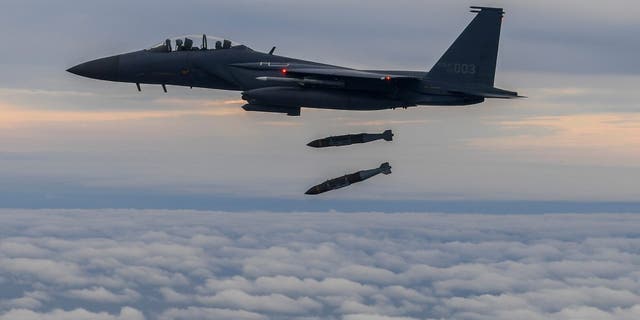 In this photo provided by South Korea Defense Ministry, South Korean Air Force's F15K fighter jet fires 2 JDAM (Joint Direct Attack Munition) bombs into an island target in South Korea on Oct. 4, 2022. 