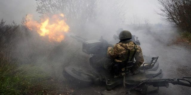 Ukrainian National guard soldiers fire at Russian positions from an anti-aircraft gun in Kharkiv region, Ukraine, Friday, Nov. 11, 2022. 