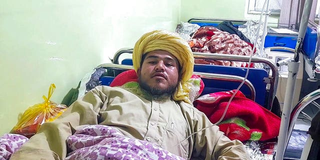 A wounded man receives treatment at a hospital after a deadly bomb blast at a religious school in Aybak, the capital of the Samangan province in northern Afghanistan, Wednesday, Nov. 30, 2022. The blast Wednesday at a madrassa killed at least 10 and wounded a number of students, a Taliban official said. 