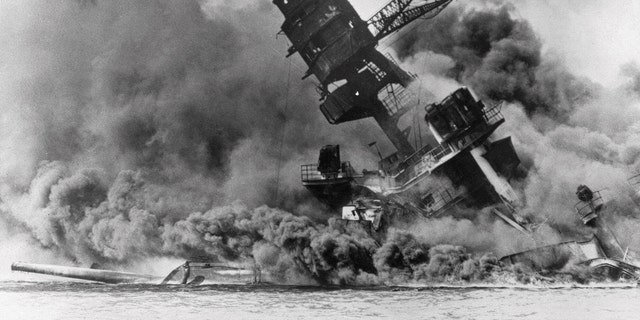 FILE - In this photo provided by the U.S. Navy, smoke rises from the battleship USS Arizona as it sinks during the Japanese attack on Pearl Harbor, Hawaii, Dec. 7, 1941. The U.S. Navy and the National Park Service will host a remembrance ceremony at Pearl Harbor in December 2022, the 81st anniversary of the 1941 Japanese bombing.