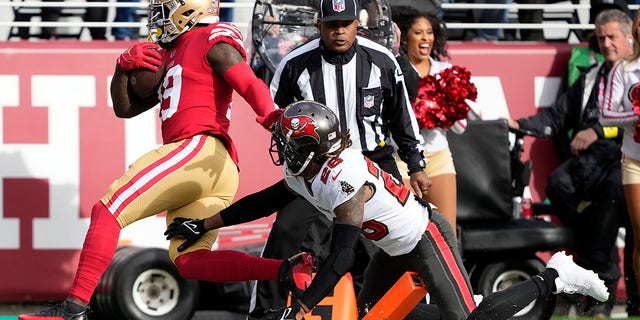 San Francisco 49ers wide receiver Deebo Samuel scores a touchdown against the Tampa Bay Buccaneers in Santa Clara, California, Sunday, Dec. 11, 2022.