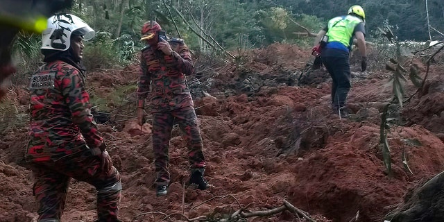 In this photo released by Korporat JBPM, rescuers work during a rescue and evacuation operation following a landslide at a campsite in Batang Kali, Selangor state, on the outskirts of Kuala Lumpur, Malaysia, Dec. 16, 2022.