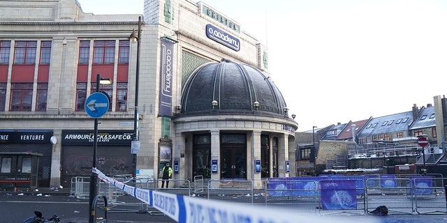 The scene outside Brixton O2 Academy where police are investigating the circumstances which led to four people sustaining critical injuries in an apparent crush as a large crowd tried to force their way into the south London concert venue, Friday Dec. 16, 2022.