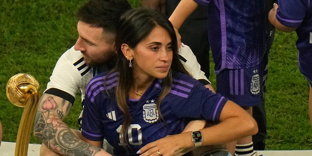 Lionel Messi sits with his wife Antonela Roccuzzo after Argentina won the World Cup in Lusail, Qatar, Sunday, Dec. 18, 2022.