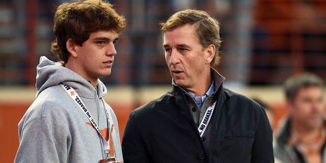 Texas Longhorns recruit Arch Manning, left, chats with his father Cooper Manning prior to Big 12 football game between the TCU Horned Frogs and the Texas Longhorns on Nov. 12, 2022 at Darrell K Royal - Texas Memorial Stadium in Austin, Texas