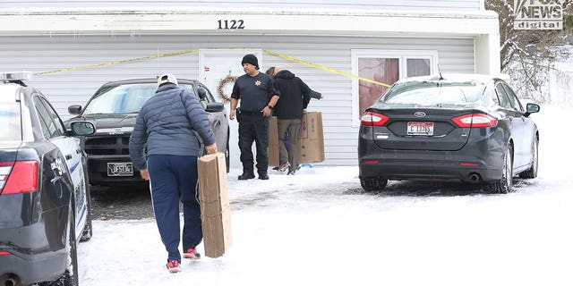 The belongings of the victims of the Univeristy of Idaho quadruple homicide are removed from the house in Moscow, Idaho, Wednesday, December 7, 2022.