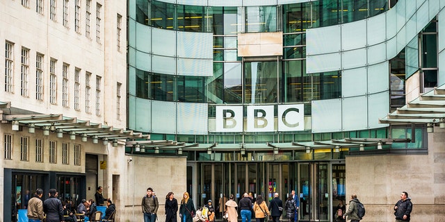 People outside the main entrance to the BBC's Broadcasting House building in central London.