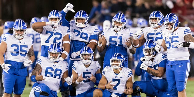 PALO ALTO, CA - NOVEMBER 26: The BYU Cougars football team, including Houston Heimuli #35, Sione Veikoso #72, Kingsley Suamataia #78, Alden Tofa #51, Joe Tukuafu #52, Lorenzo Fauatea #55, Peter Falaniko #68 and others, pose for a group photo prior to an NCAA college football game against the Stanford Cardinal on November 26, 2022, at Stanford Stadium in Palo Alto, California. 